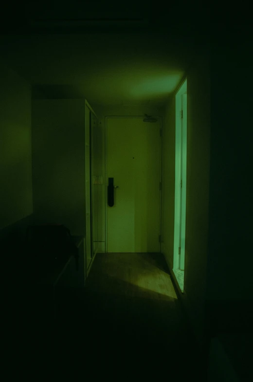 a dimly lit room with an open door, inspired by Elsa Bleda, green light, terrifying :7, liminal space aesthetic, uv