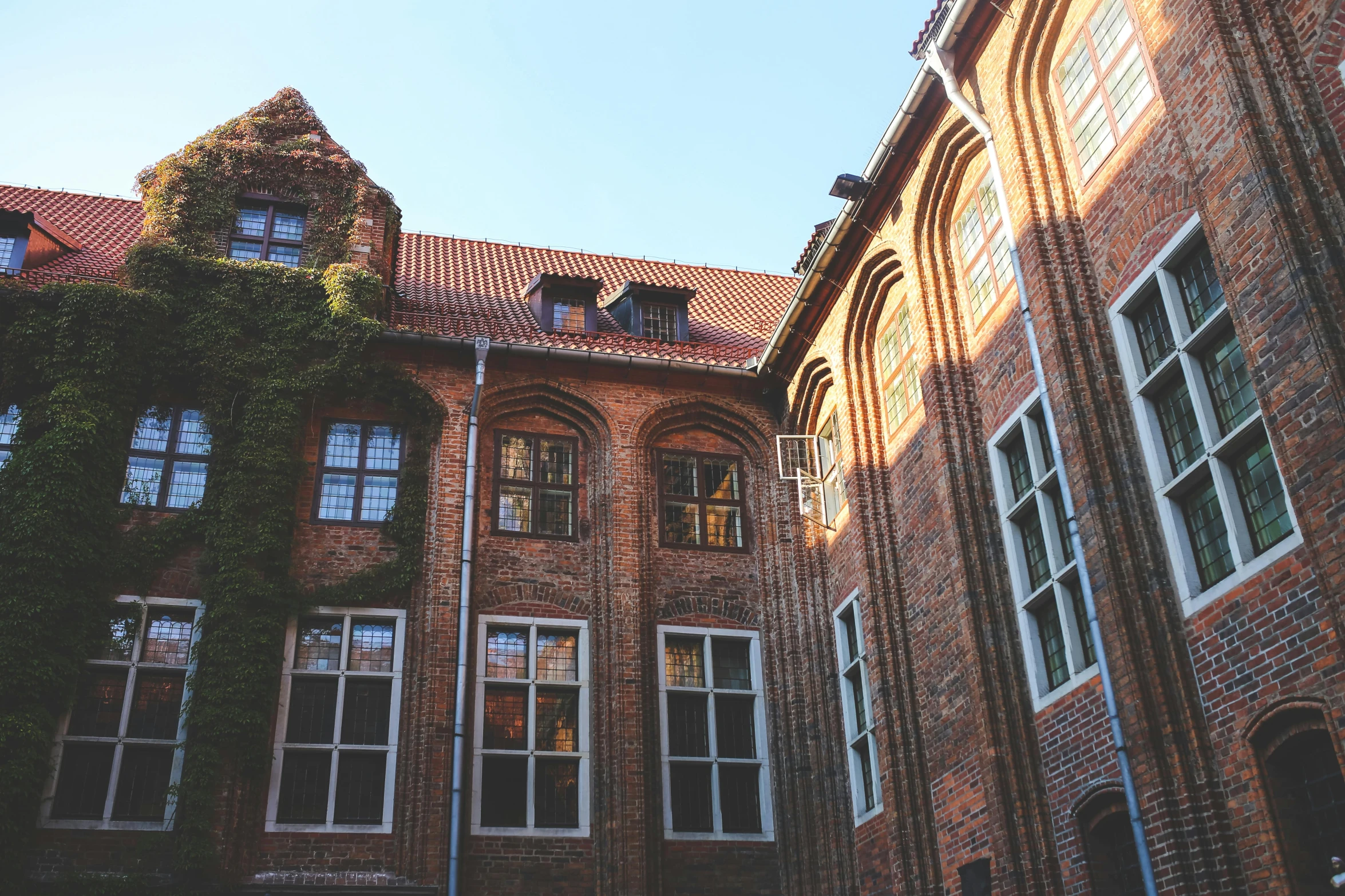 a tall brick building with lots of windows, pexels contest winner, heidelberg school, courtyard, sunfaded, fall season, summertime