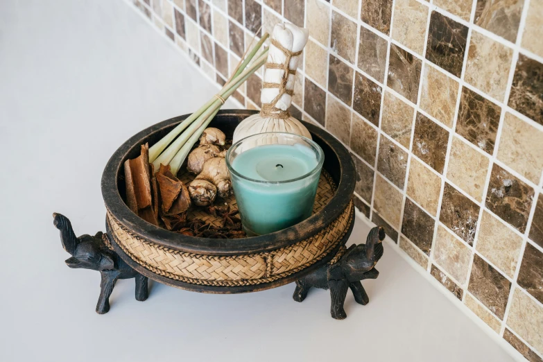 a candle that is sitting in a bowl, trending on unsplash, renaissance, teal, thai, carrying a tray, various posed