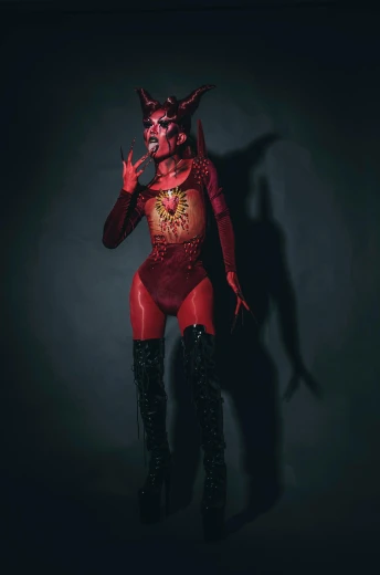 a woman in a devil costume posing for a picture, an album cover, featured on zbrush central, bodypaint, instagram photo, rot, fullbody shot