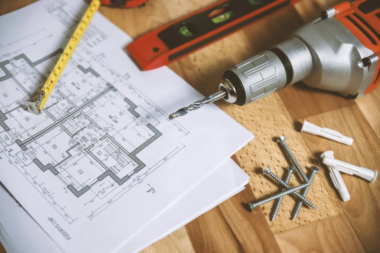 a bunch of tools sitting on top of a wooden table, a detailed drawing, pexels contest winner, building plans, screwdriver, office ceiling panels, circular