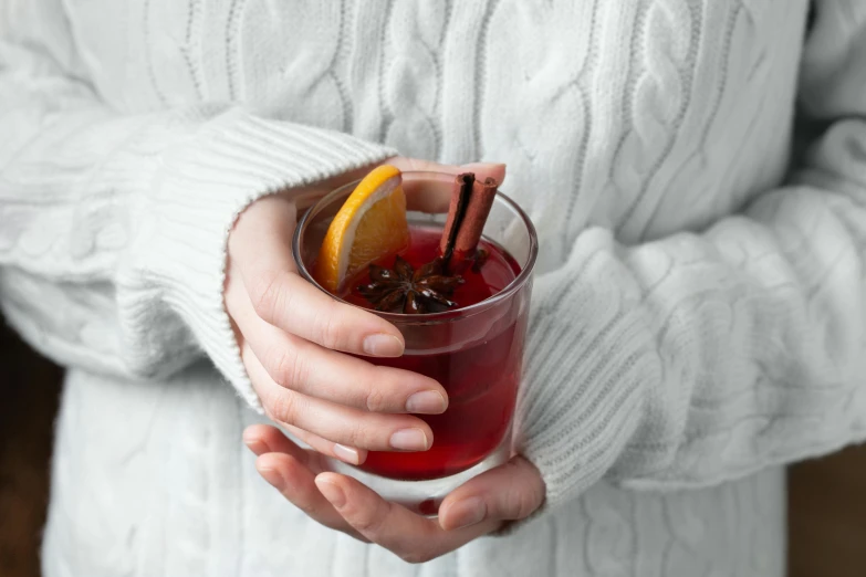 a close up of a person holding a drink, inspired by Géza Dósa, hurufiyya, maroon red, cosy, on grey background, christmas