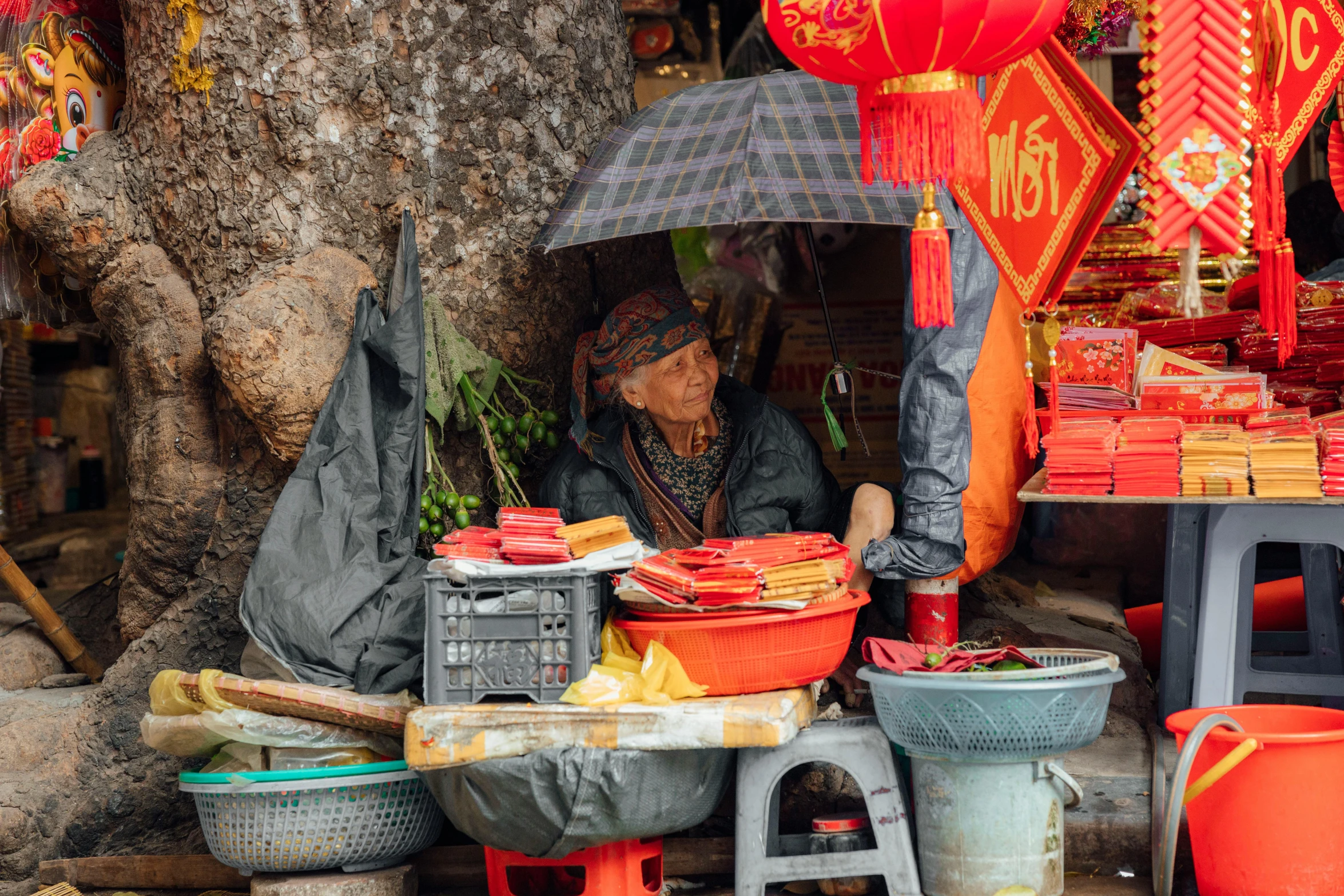 a woman sitting under an umbrella at a market, pexels contest winner, cloisonnism, red flags, avatar image, vietnamese temple scene, thumbnail