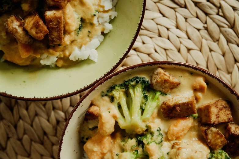 a close up of two bowls of food on a table, by Julia Pishtar, broccoli, creamy, stew, lifestyle