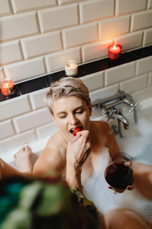 a woman sitting in a bathtub with a glass of wine, inspired by Elsa Bleda, pexels, eating rotting fruit, lesbians, candy treatments, red mouth