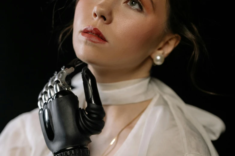 a woman in a white shirt and black gloves, inspired by Romaine Brooks, trending on pexels, wearing bionic implants, silicone skin, glossy photo, pearlescent skin