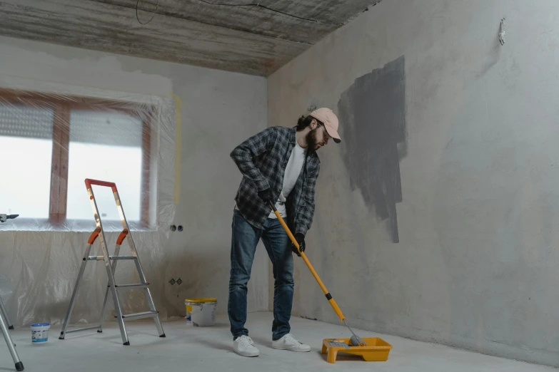 a man that is standing in a room with a mop, hard paint, profile image, grey, construction