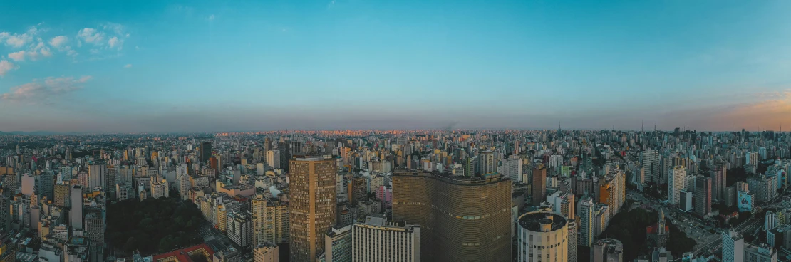 a view of a city from the top of a building, futuristic sao paulo, low quality photo, at golden hour, tourist photo