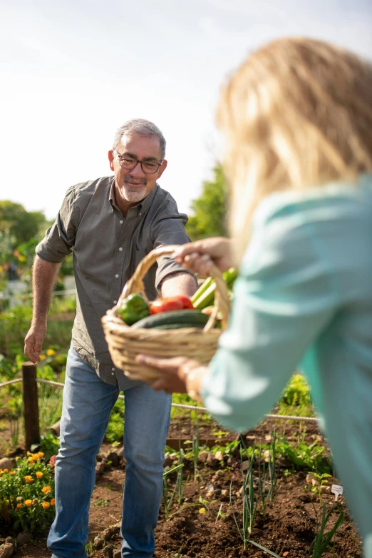 a man standing next to a woman holding a basket of vegetables, happening, gardens, profile image, pleasing, rectangle
