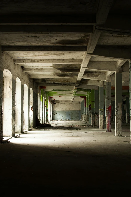 an empty building with graffiti all over it, unsplash contest winner, deep shadows and colors, fallen columns, green alleys, ignant