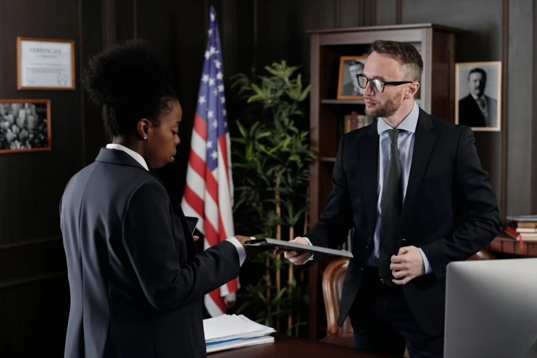 a man and a woman standing in front of a computer, holding court, ( ( theatrical ) ), profile image