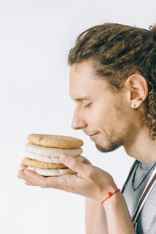 a man with dreadlocks eating a sandwich, by Adam Marczyński, unsplash, renaissance, sexy sesame seed buns, on white background, stacked, headshot profile picture