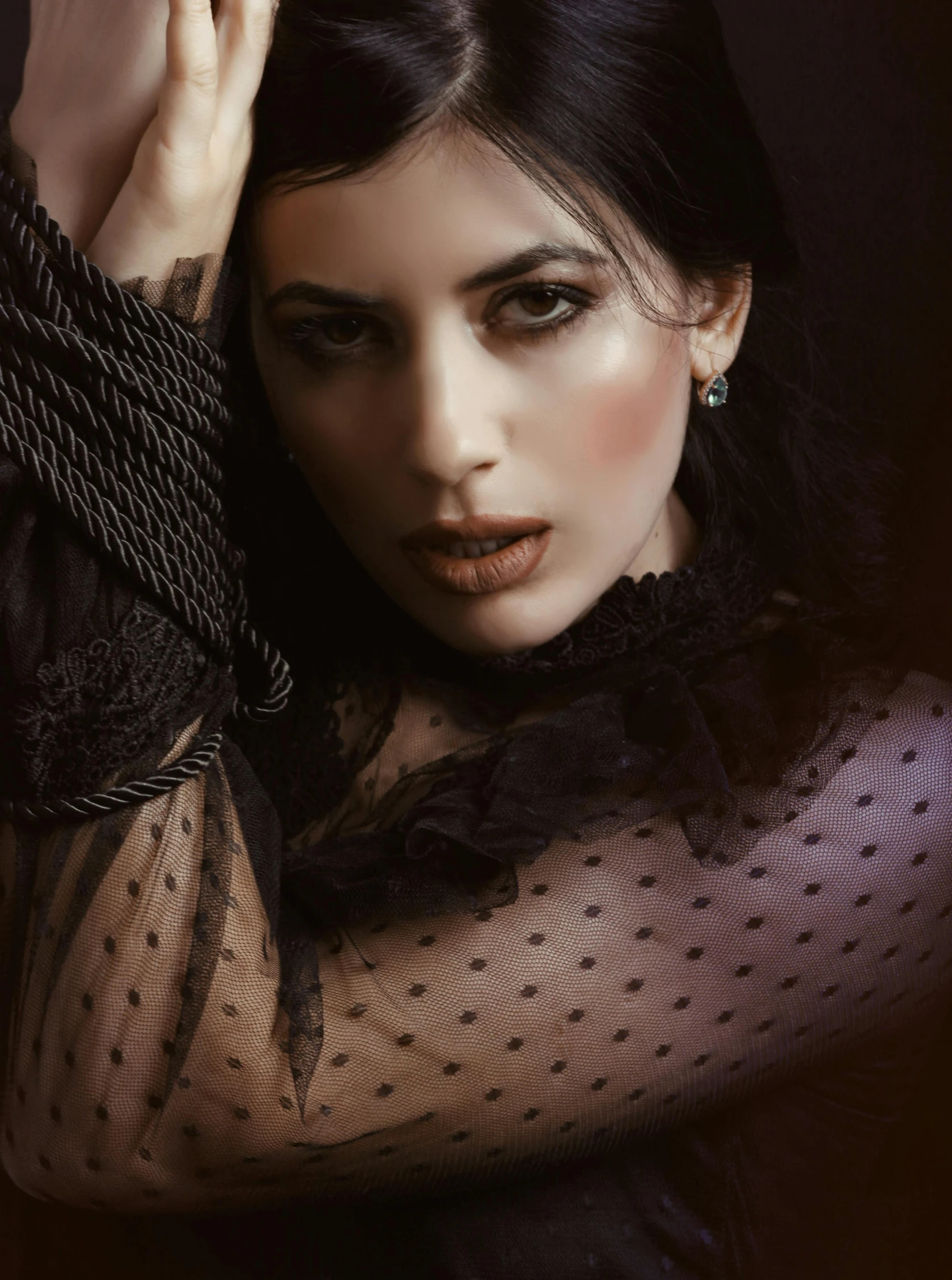 a woman in a black dress posing for a picture, inspired by Elsa Bleda, trending on pexels, gothic art, black hair and brown eyes, vintage photo, translucent skin, feral languid emma roberts