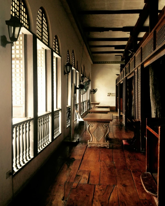 a room filled with lots of windows next to a wooden floor, inspired by Luis Paret y Alcazar, renaissance, manila, walkway, museum archive, conde nast traveler photo