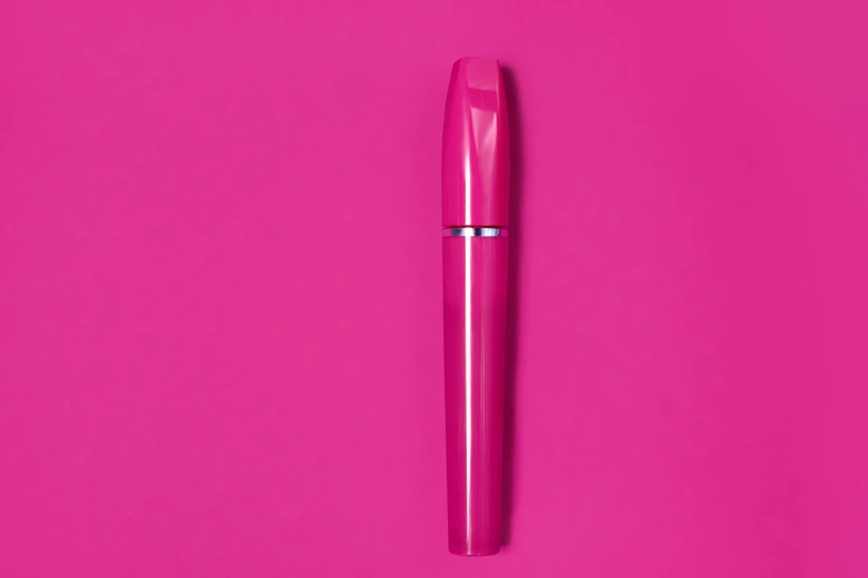 a pink pen sitting on top of a pink surface, by Daniel Gelon, pop art, mascara, gloss finish, titanium, high quality product image”