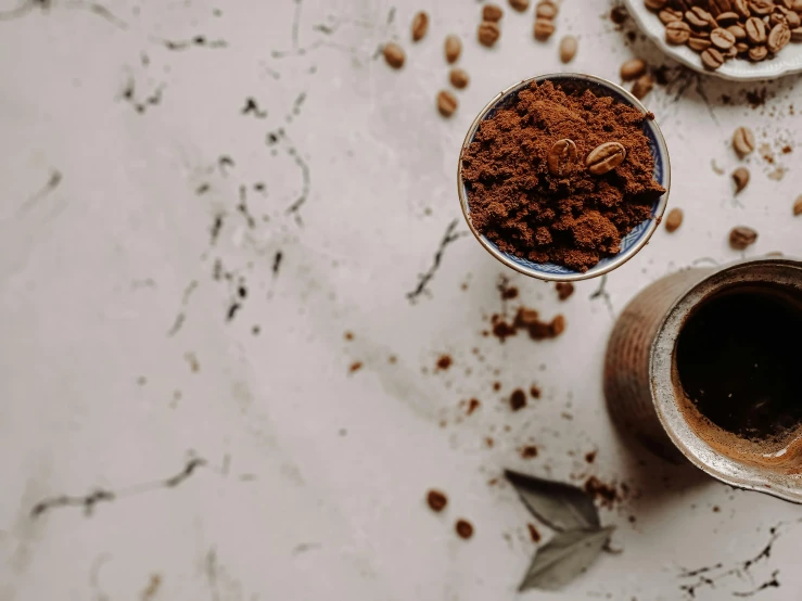 a couple of cups of coffee sitting on top of a table, product image, powder, botanicals, detail shot