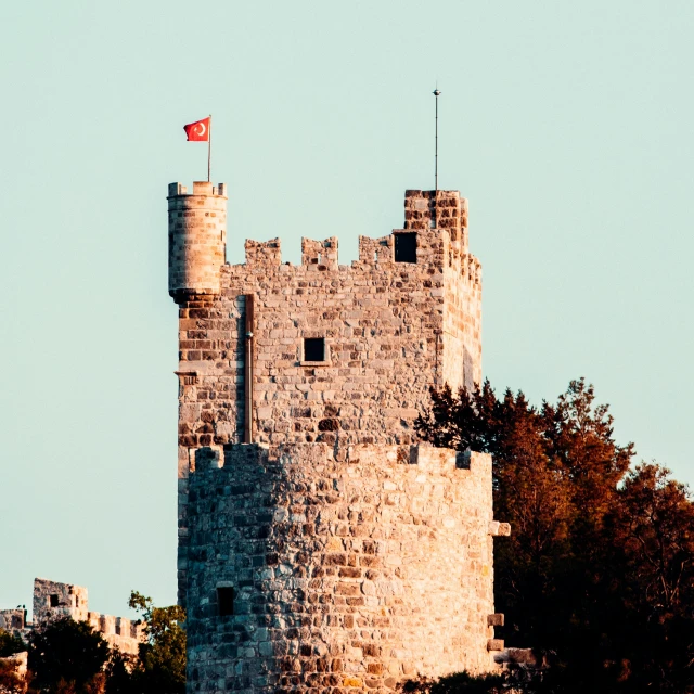 a stone tower with a flag on top of it, pexels contest winner, baris yesilbas, square, manly, high walls