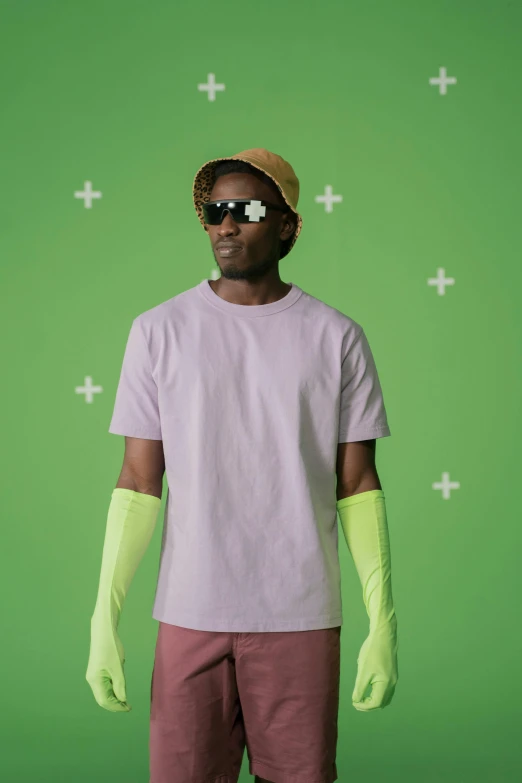 a man standing in front of a green screen, by Peter Alexander Hay, trending on pexels, color field, purple outfit, wearing sunglasses and a cap, young thug, wearing gloves
