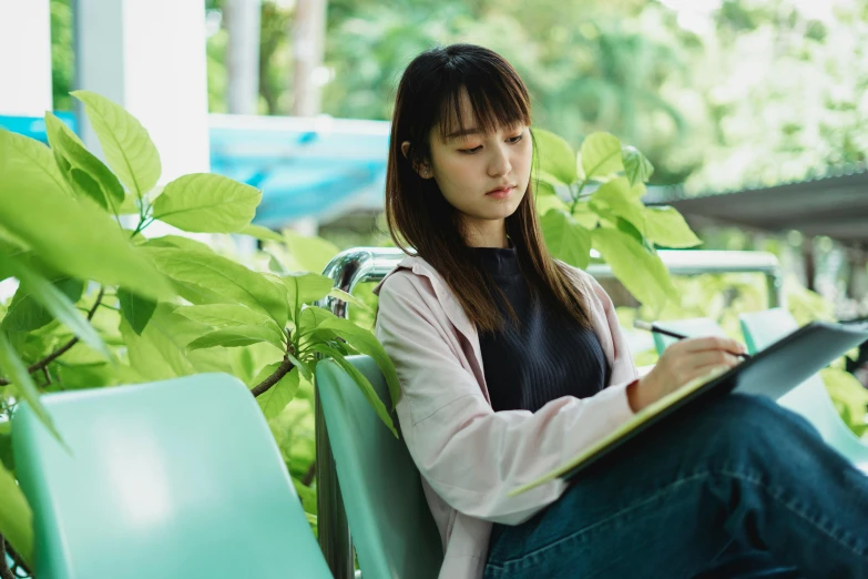 a woman sitting on a bench with a laptop, inspired by Kim Jeong-hui, pexels contest winner, academic art, holding a clipboard, wearing green clothing, ethnicity : japanese, studious