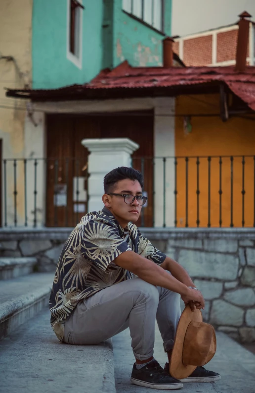 a man sitting on the steps of a building, a picture, inspired by Jorge Jacinto, pexels contest winner, hyperrealism, with hawaiian shirt, casual pose, in a square, he is about 20 years old | short