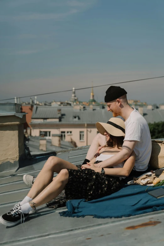 a man and a woman sitting on top of a roof, by Zofia Stryjenska, pexels contest winner, chill summer, low quality photo, 256435456k film, moscow