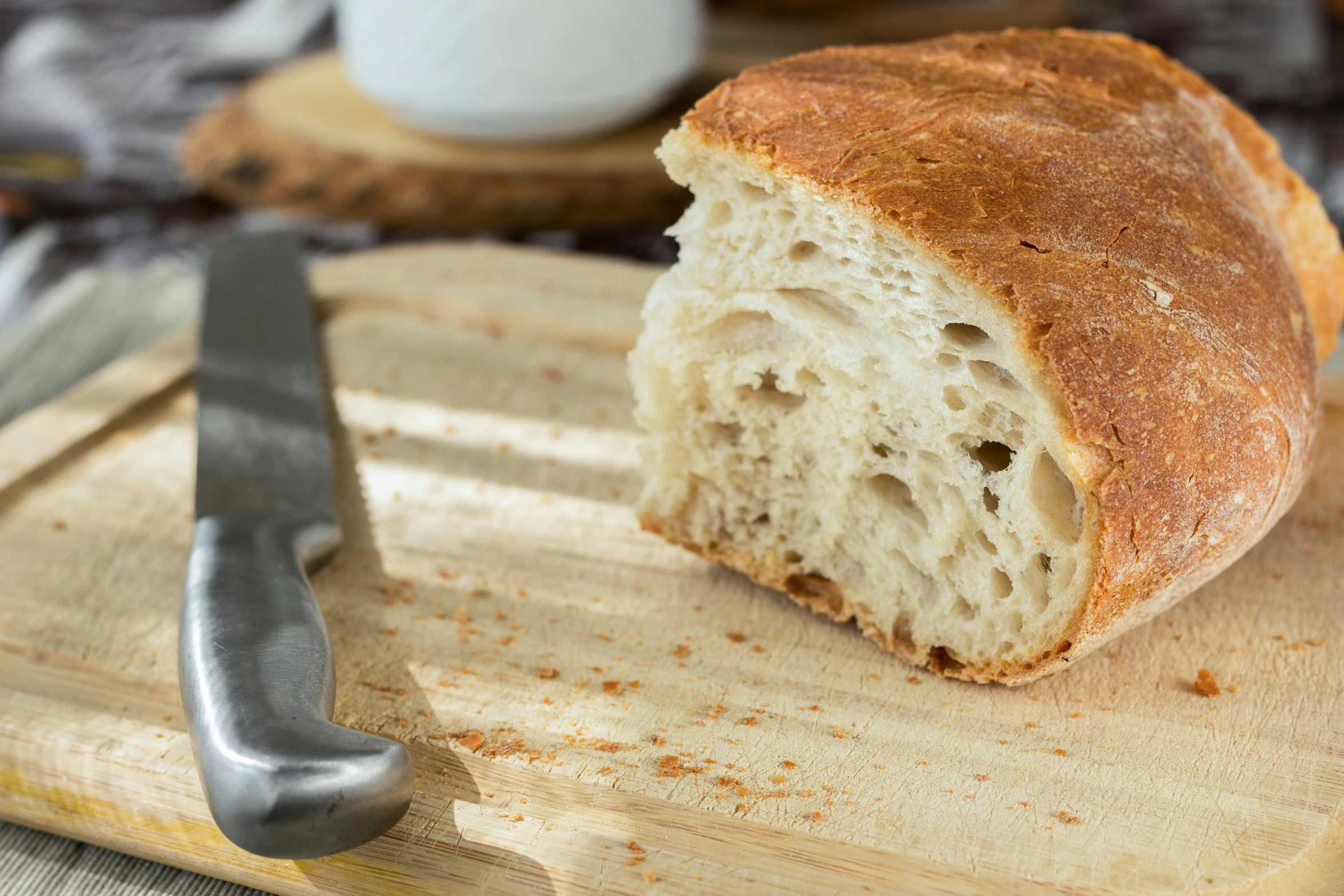 a loaf of bread sitting on top of a cutting board, inspired by Richmond Barthé, unsplash, medium close up shot, detailed product image, half image, upscaled to high resolution