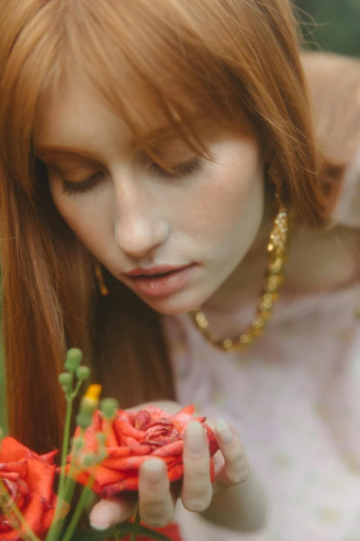 a woman holding a bouquet of flowers in her hands, inspired by Oleg Oprisco, trending on pexels, renaissance, soft red hair, thoughtful ), gold and pearl necklaces, cottagecore