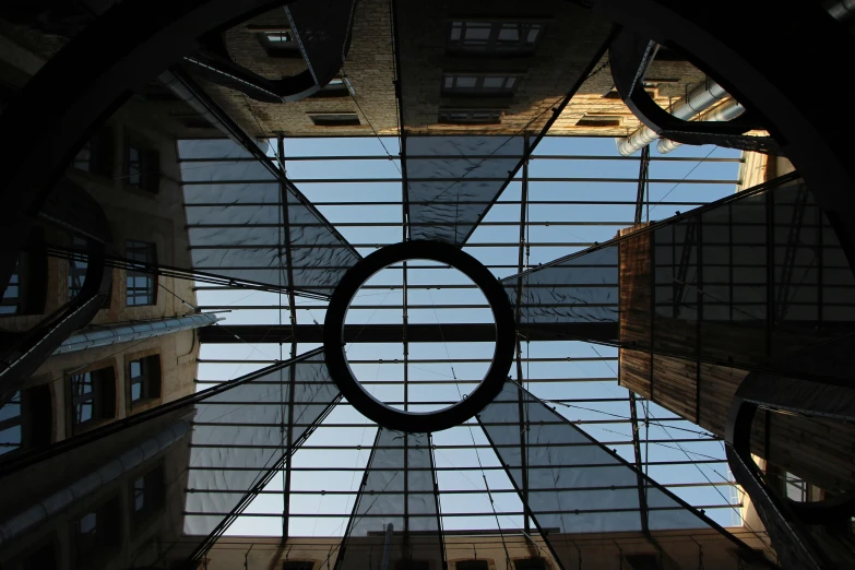 the inside of a building looking up at the sky, an album cover, pexels contest winner, courtyard, solar sails, large round window, gothic quarter