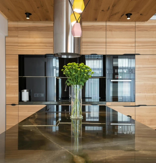 a vase of flowers sitting on top of a kitchen counter, light and space, office ceiling panels, ashford black marble, polished with visible wood grain, polished concrete