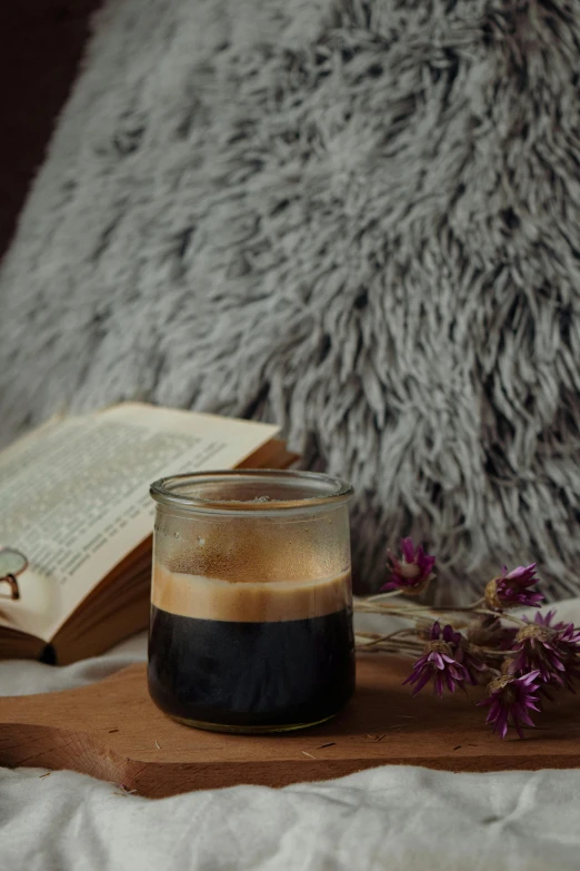 a cup of coffee and a book on a bed, by Lucia Peka, reddit, cold brew coffee ), with soft bushes, studio shot, black and brown