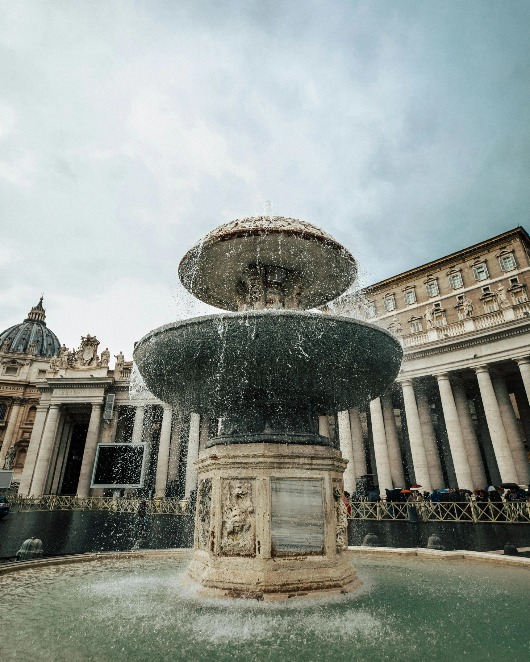 a fountain in front of a large building, by Cagnaccio di San Pietro, pexels contest winner, gay, john paul ii, high resolution photo, multiple stories