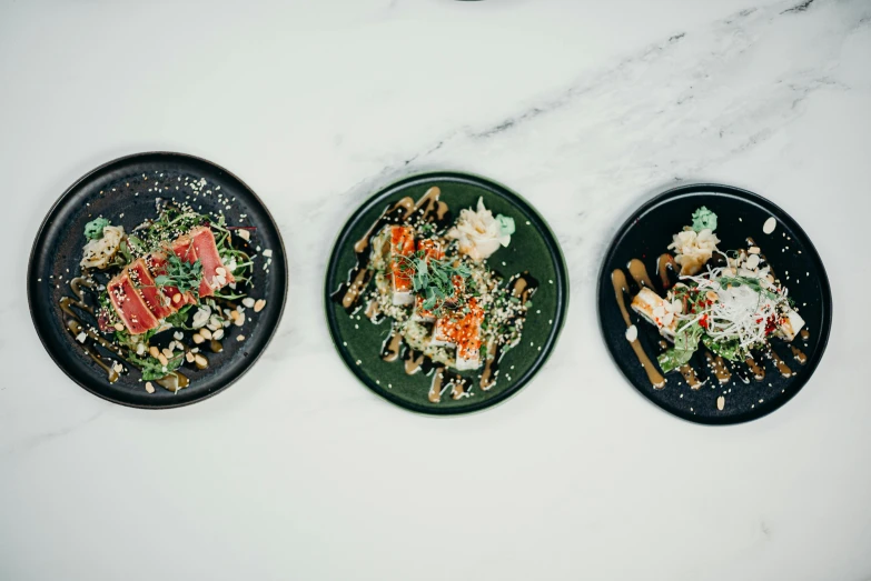 three plates with different types of food on them, unsplash, mingei, all marble, dwell, central shot, yum