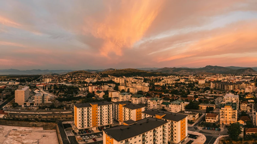 an aerial view of a city at sunset, by Kristian Zahrtmann, pexels contest winner, slovakia, soviet apartment buildings, panorama view of the sky, stacked image