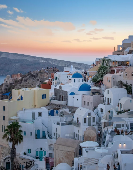 a number of buildings near a body of water, a picture, trending on unsplash, neoclassicism, santorini, sunset photo, vogue cover photo, 2 0 0 0's photo