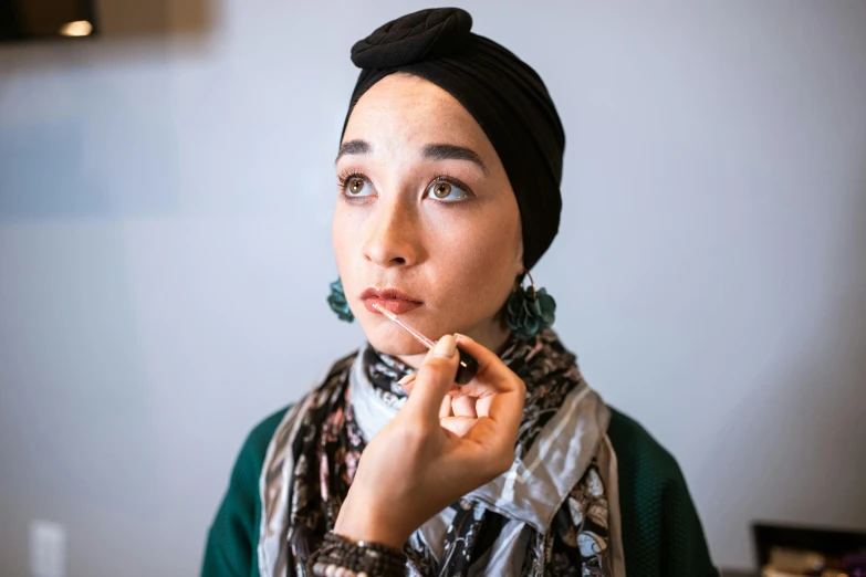 a woman in a turban poses for a picture, by Maryam Hashemi, trending on pexels, hyperrealism, kiko mizuhara, hand on her chin, an intricate, islamic