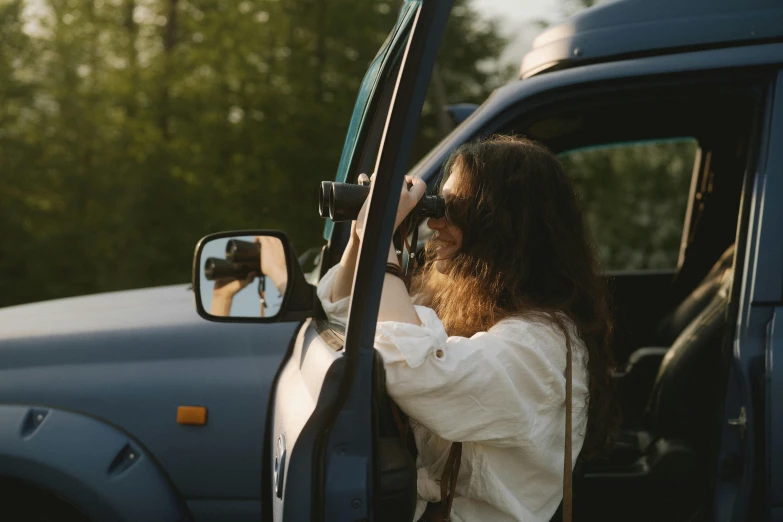 a woman taking a picture of herself in a car, pexels contest winner, side profile shot, cottagecore hippie, looking sideway, avatar image