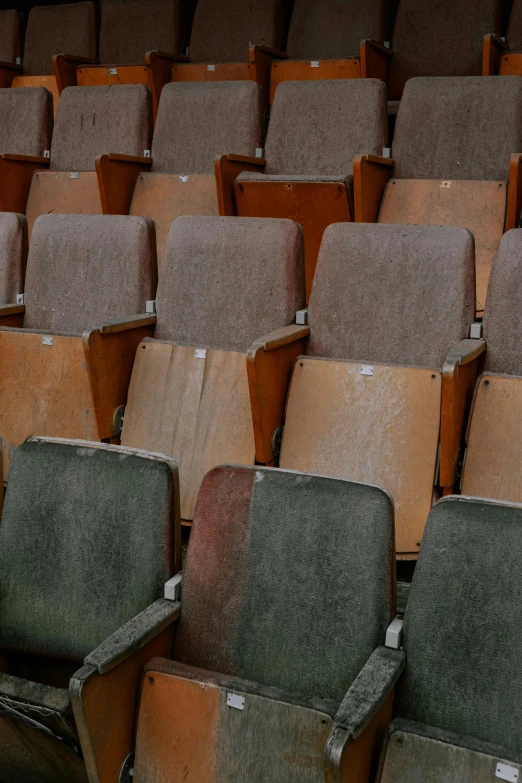 a row of empty seats in an auditorium, an album cover, by Elsa Bleda, modernism, ((rust)), brown, grey, distressed