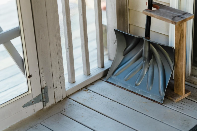 a close up of a snow shovel on a porch, unsplash, open door, background image, multiple stories, slide show