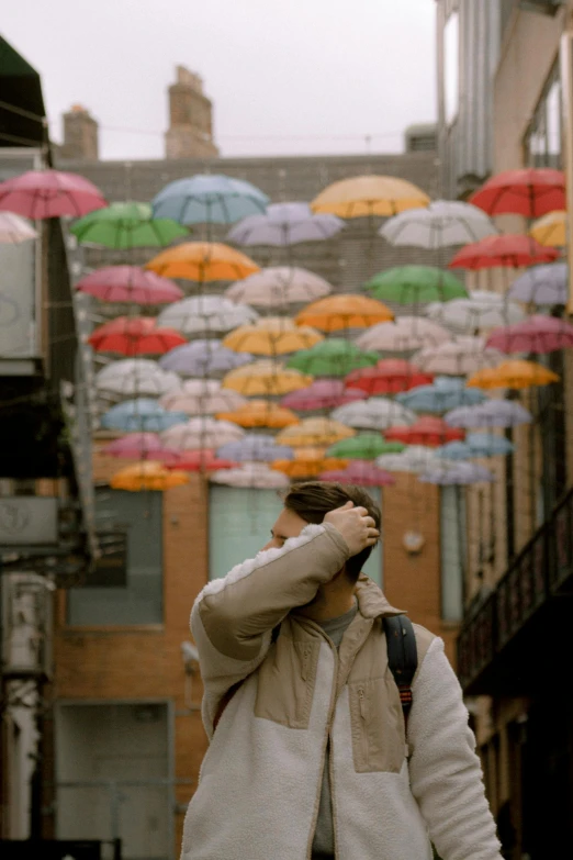 a man walking down a street while talking on a cell phone, by Matt Stewart, unsplash contest winner, conceptual art, umbrellas, colorful]”, profile pic, color film