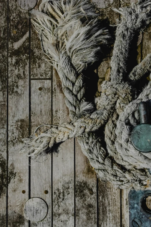 a close up of a rope on a boat, an album cover, vintage muted colors, dressed in a worn, vessels, promo image