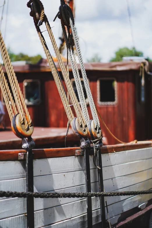 a close up of a boat on a body of water, wooden sailboats, on a boat