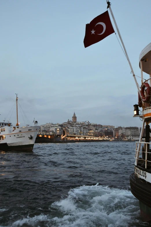 a couple of boats that are in the water, by Jan Tengnagel, happening, istanbul, dim dusk lighting, amsterdam, low quality photo