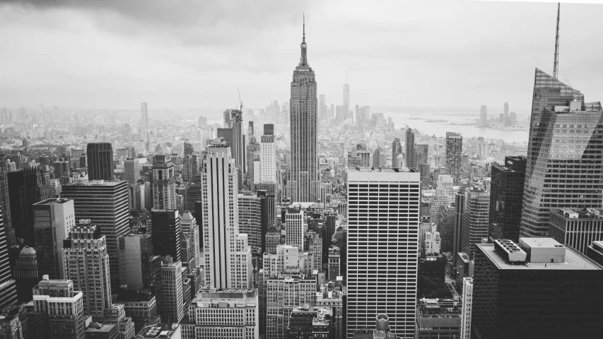 a black and white photo of a city, by Adam Rex, pexels contest winner, ny, on a cloudy day, empire, famous