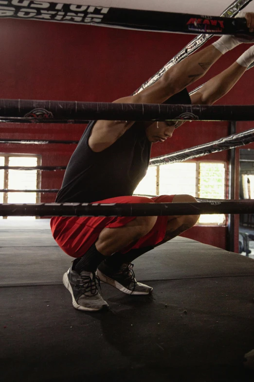 a man doing a handstand in a boxing ring, squatting, david marquez, contemplating, promo image