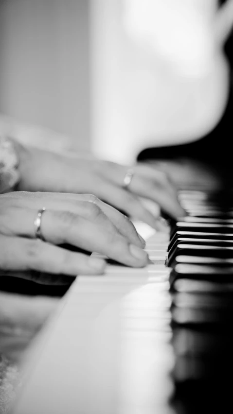 a close up of a person playing a piano, by Felix-Kelly, male and female, back and white, uploaded, pianos