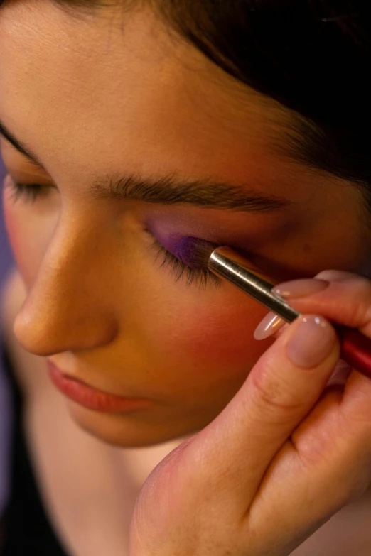 a close up of a person putting makeup on, flickr, purple themed, eyes half closed, on location, slide show