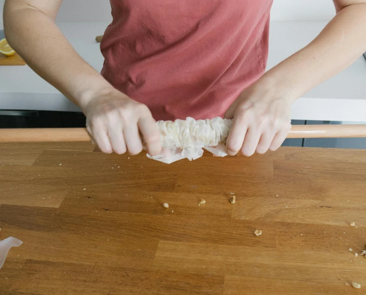 a woman preparing food on a cutting board, inspired by Sarah Lucas, unsplash, rice paper texture, holding a wooden staff, knobbly knees, obi strip