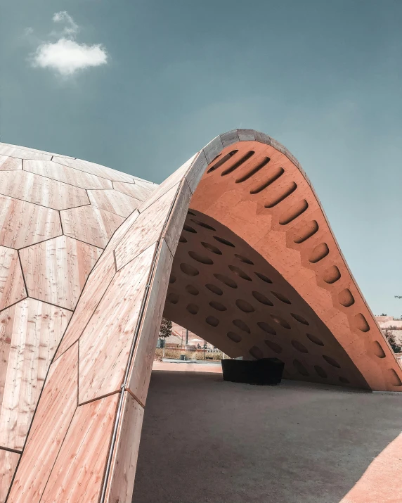 a man riding a skateboard up the side of a ramp, an abstract sculpture, inspired by Zha Shibiao, trending on unsplash, interactive art, peaked wooden roofs, turtle shell, islamic architecture, exterior view
