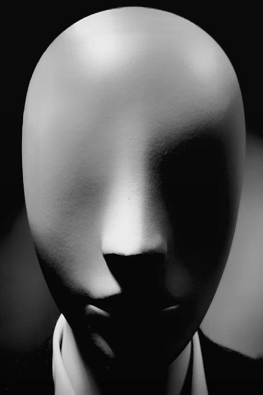 a black and white photo of a mannequin head, by Doug Ohlson, surrealism, white mask, ( ( photograph ) ), faceless, anonymous as a sausage