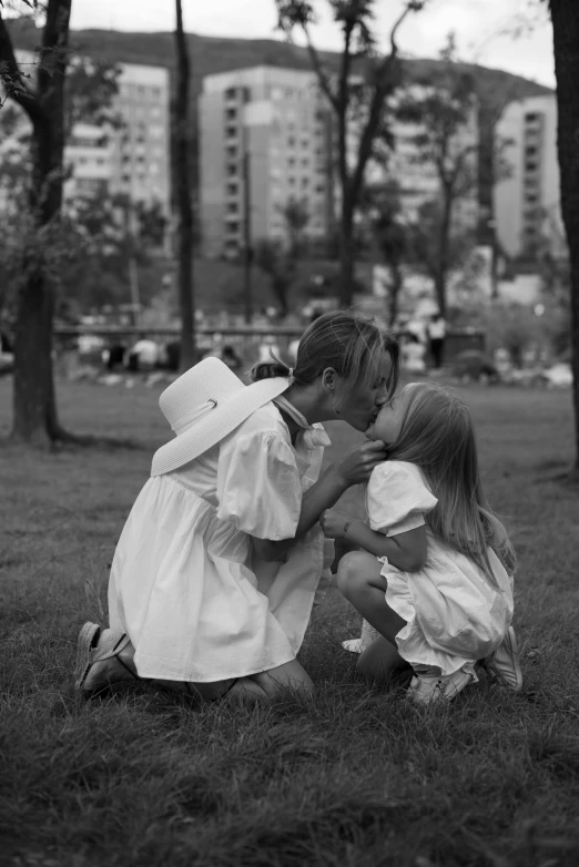 a black and white photo of two children kissing, a black and white photo, by Larry Fink, romanticism, ffffound, wearing white clothes, in the park, (beautiful) girl